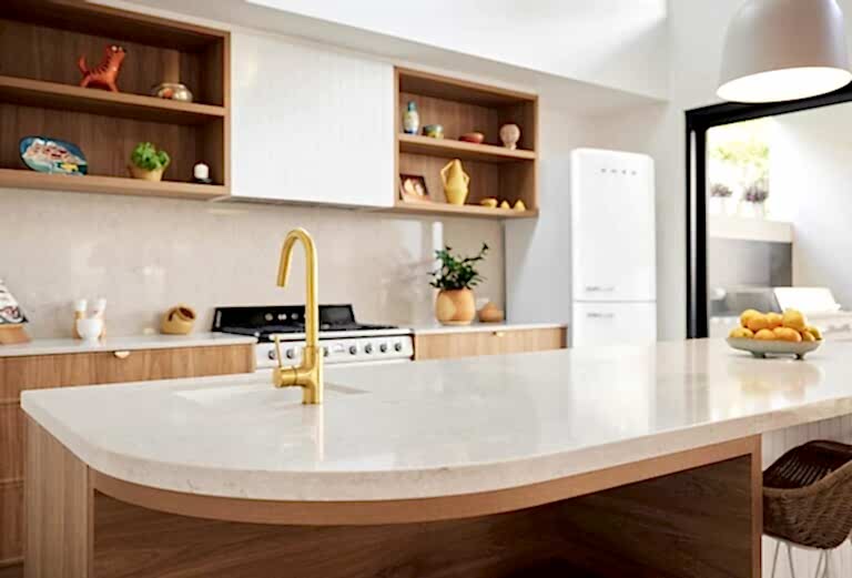 Modern custom home kitchen interior with timber cabinetry, stone island bench and brass tapware by Coast Homes
